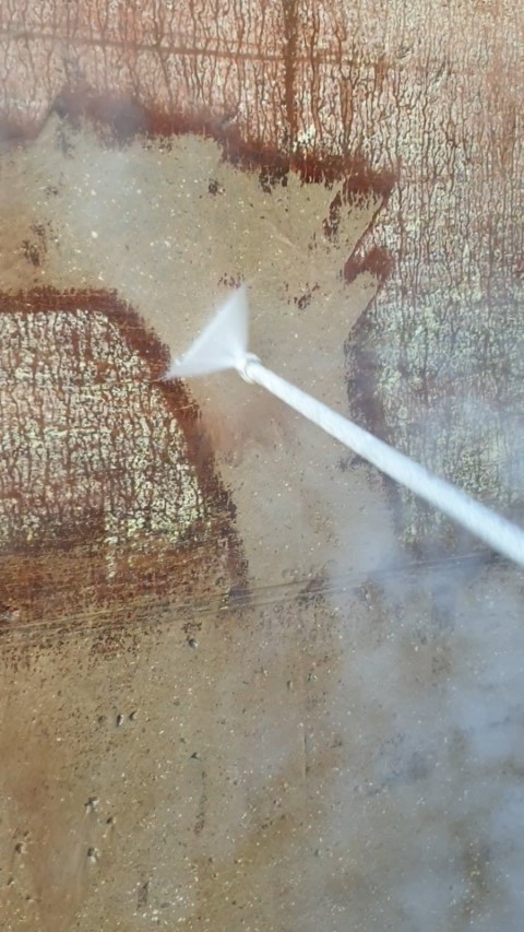 Close up of the Steam Lance cleaning debris off the concrete